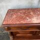 Henri II style console table with a red marble top.