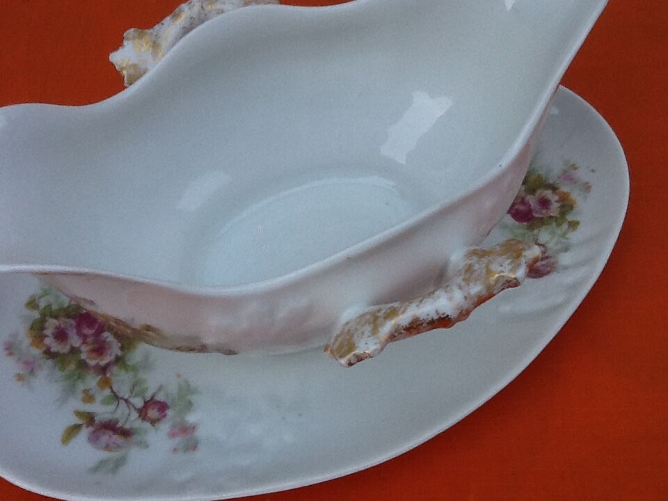 Sauce boat on dormant white porcelain, floral decoration