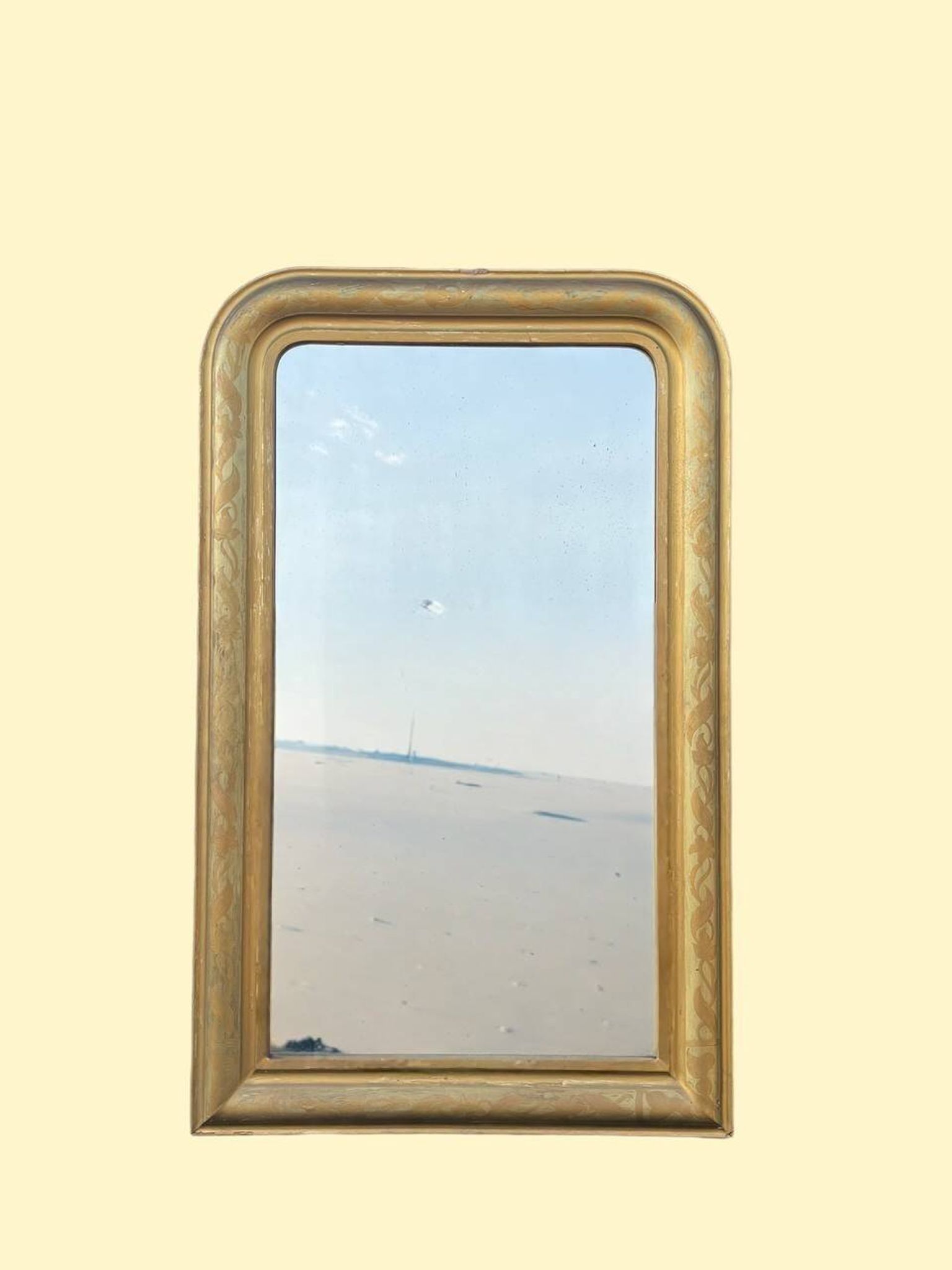 Large antique French gilded mirror with painted floral decoration.