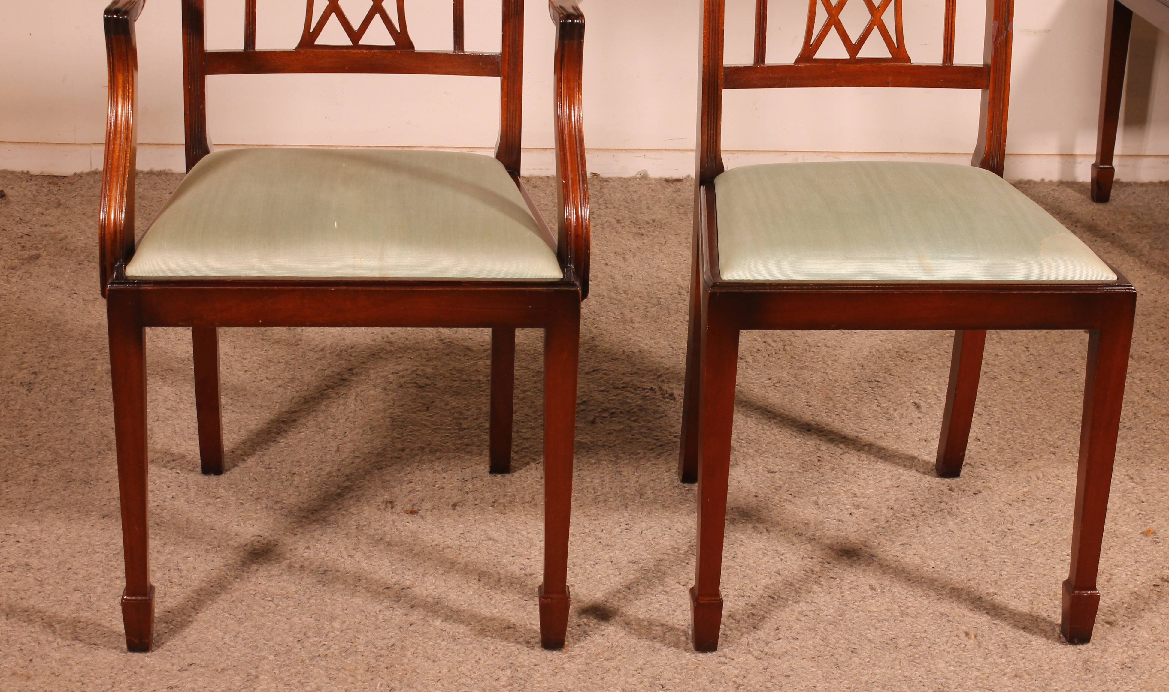 set of 10 chairs and two mahogany armchairs in Hepplewhite style