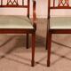 set of 10 chairs and two mahogany armchairs in Hepplewhite style