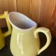 Vintage yellow ceramic teapot and milk jug.