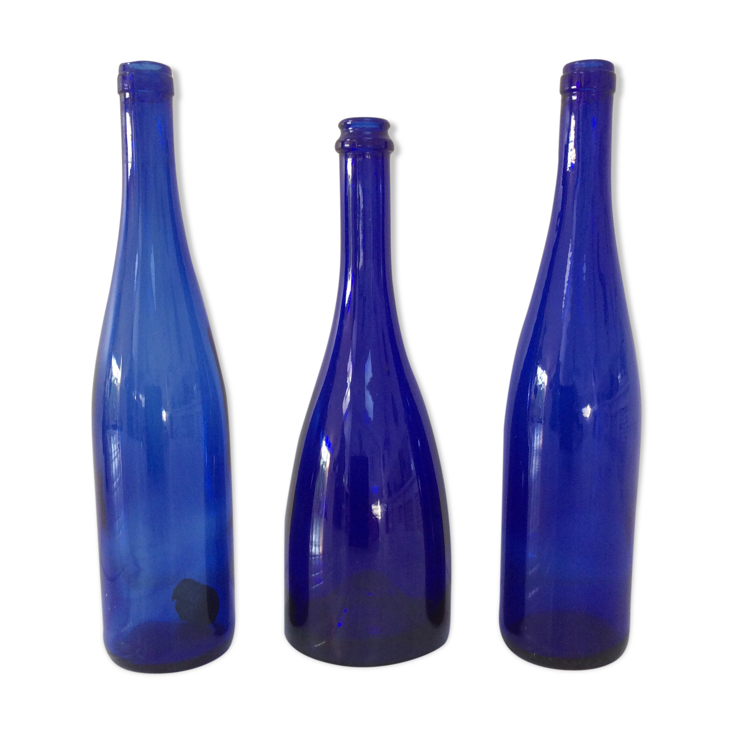 Decorative trio of old blue glass bottles