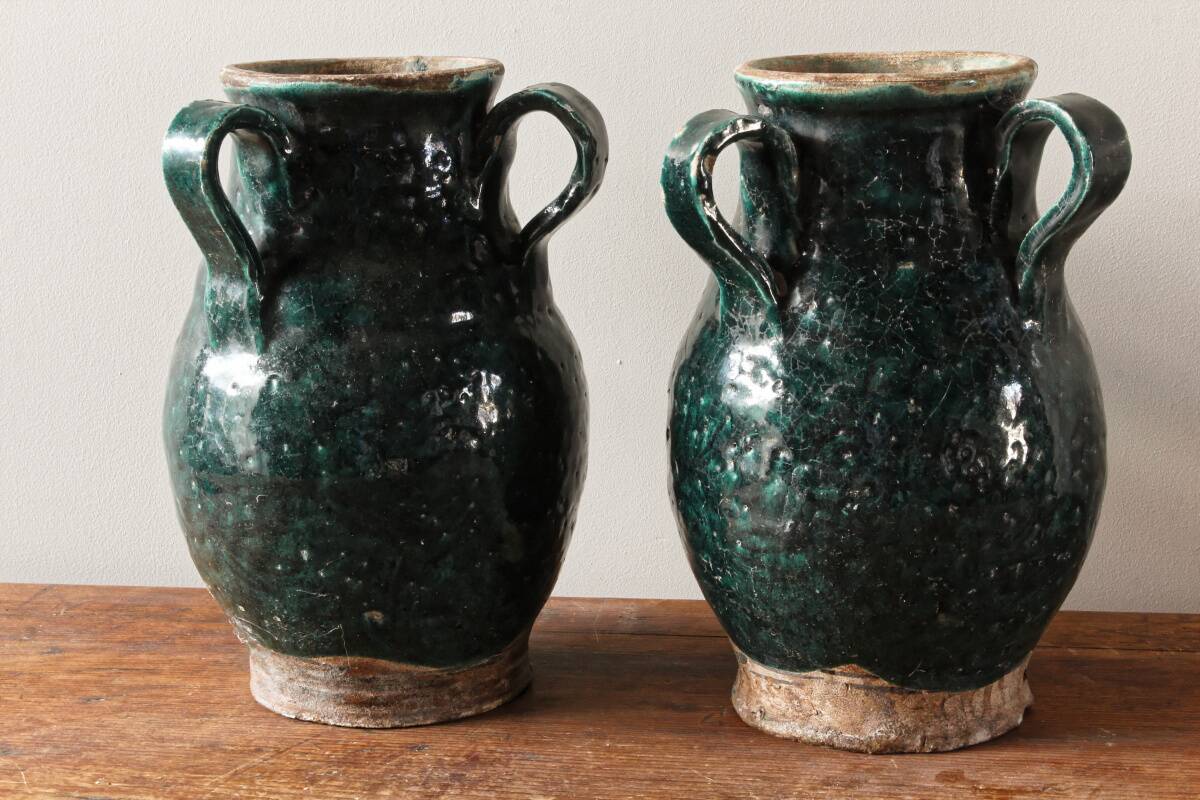 Set of two Chinese green glazed stoneware storage jars.