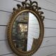 Miroir ovale patiné doré