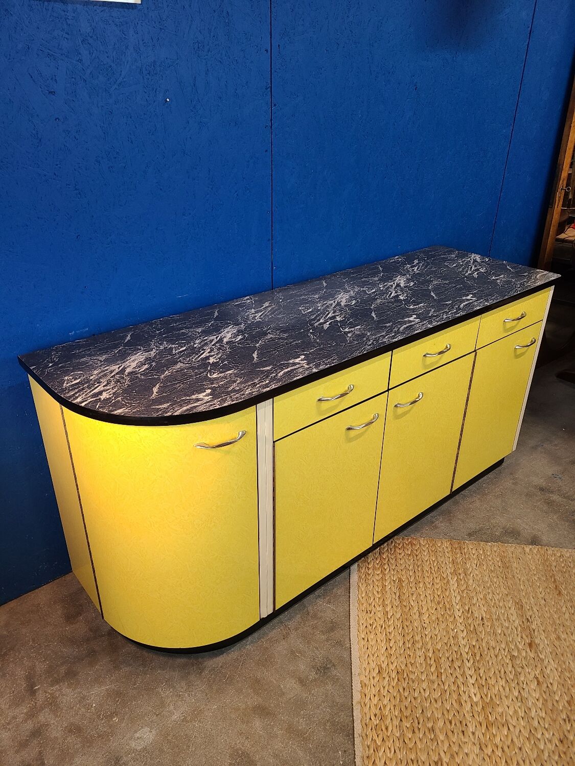 Vintage yellow sideboard, and black marble top.