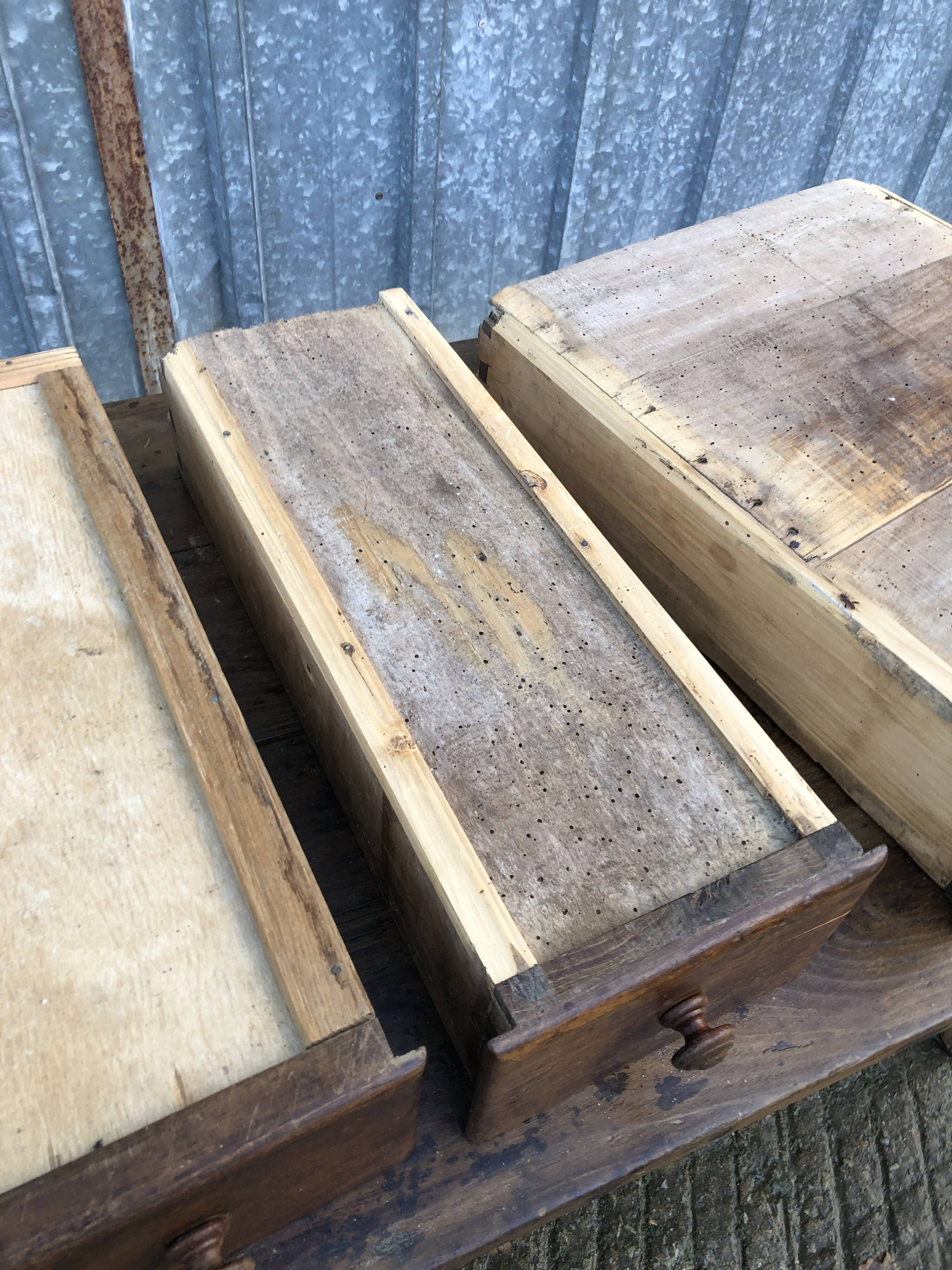Old chestnut table with 3 front drawers and a cat bar.