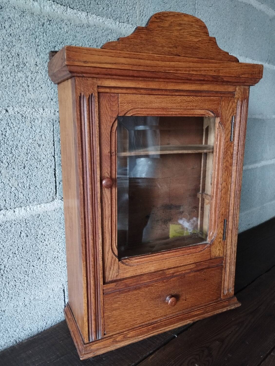 Old glass wall shelf with drawer door