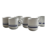 White ceramic cups with blue borders.