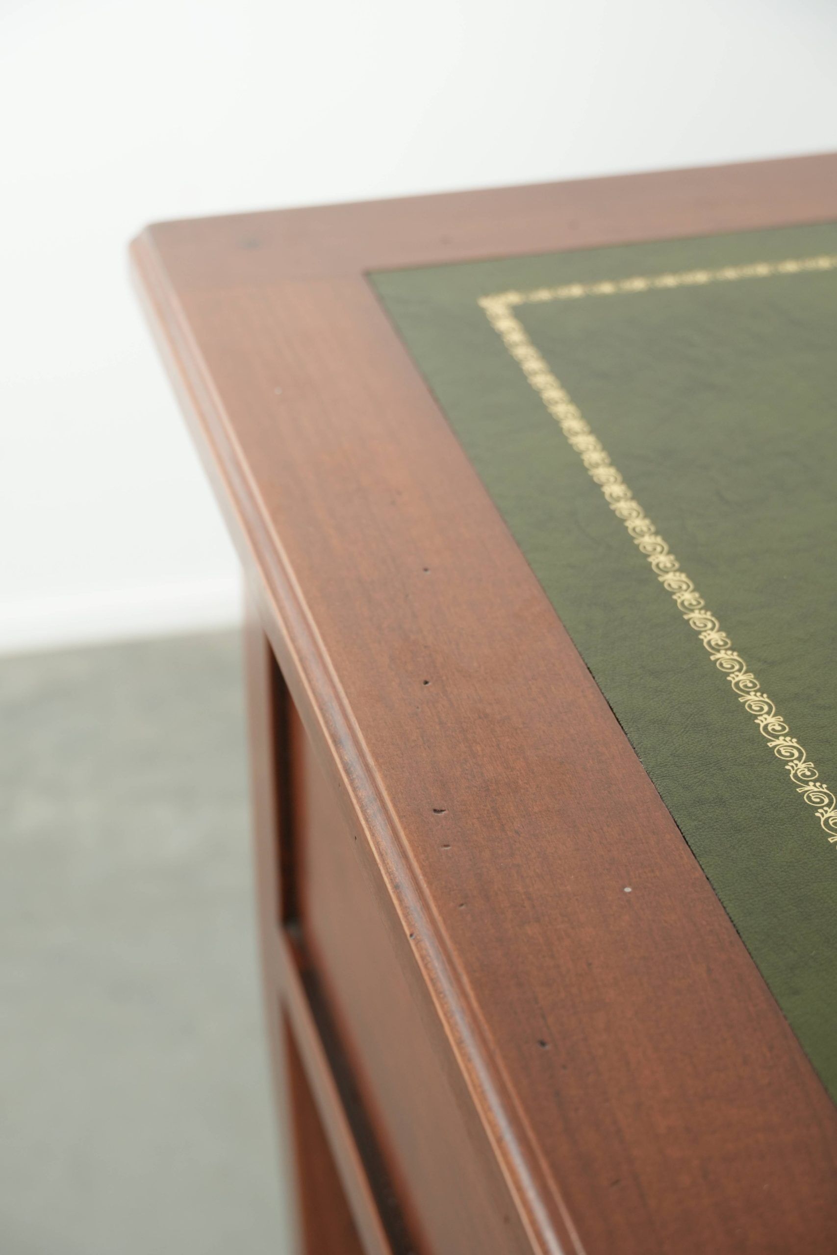 Elegant English style desk with green leather top, gold details and drawers