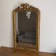 Golden mirror from the late 19th century with a decorated pediment. 130x74.