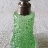 Small green bottle and old metal, single-flower vase