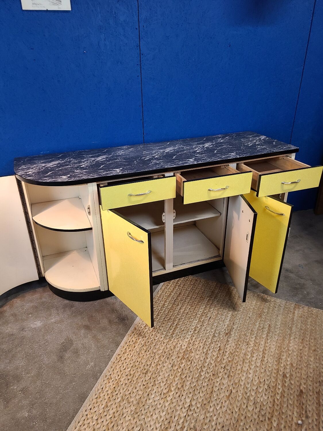 Vintage yellow sideboard, and black marble top.