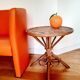 Old bamboo/rattan table with woven palm leaves.