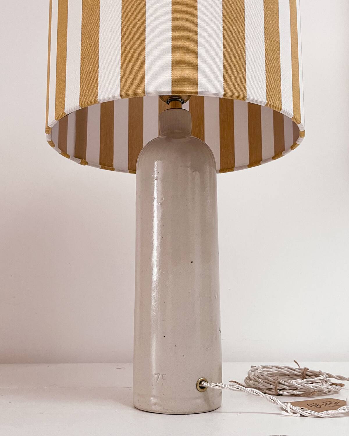 Sandstone lamp and striped lampshade