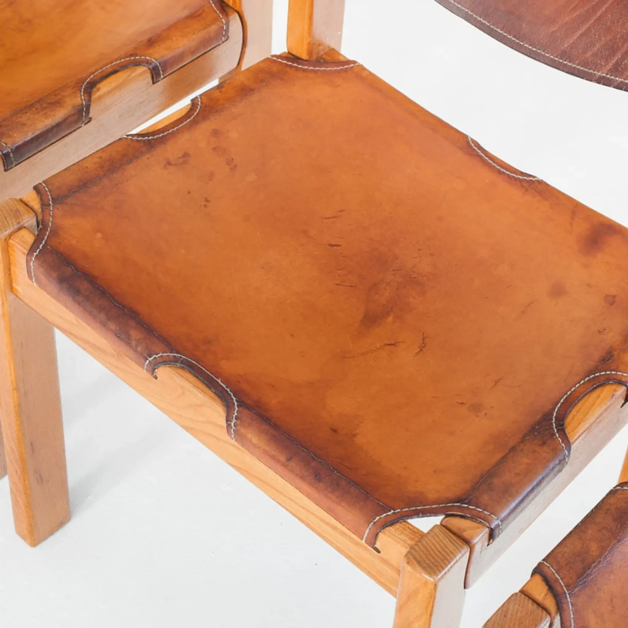 Ensemble de quatre chaises vintage. Bois d'orme et cuir. Maison Regain 70s