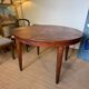 Oval extendable dining table in wood and walnut burl veneer.
