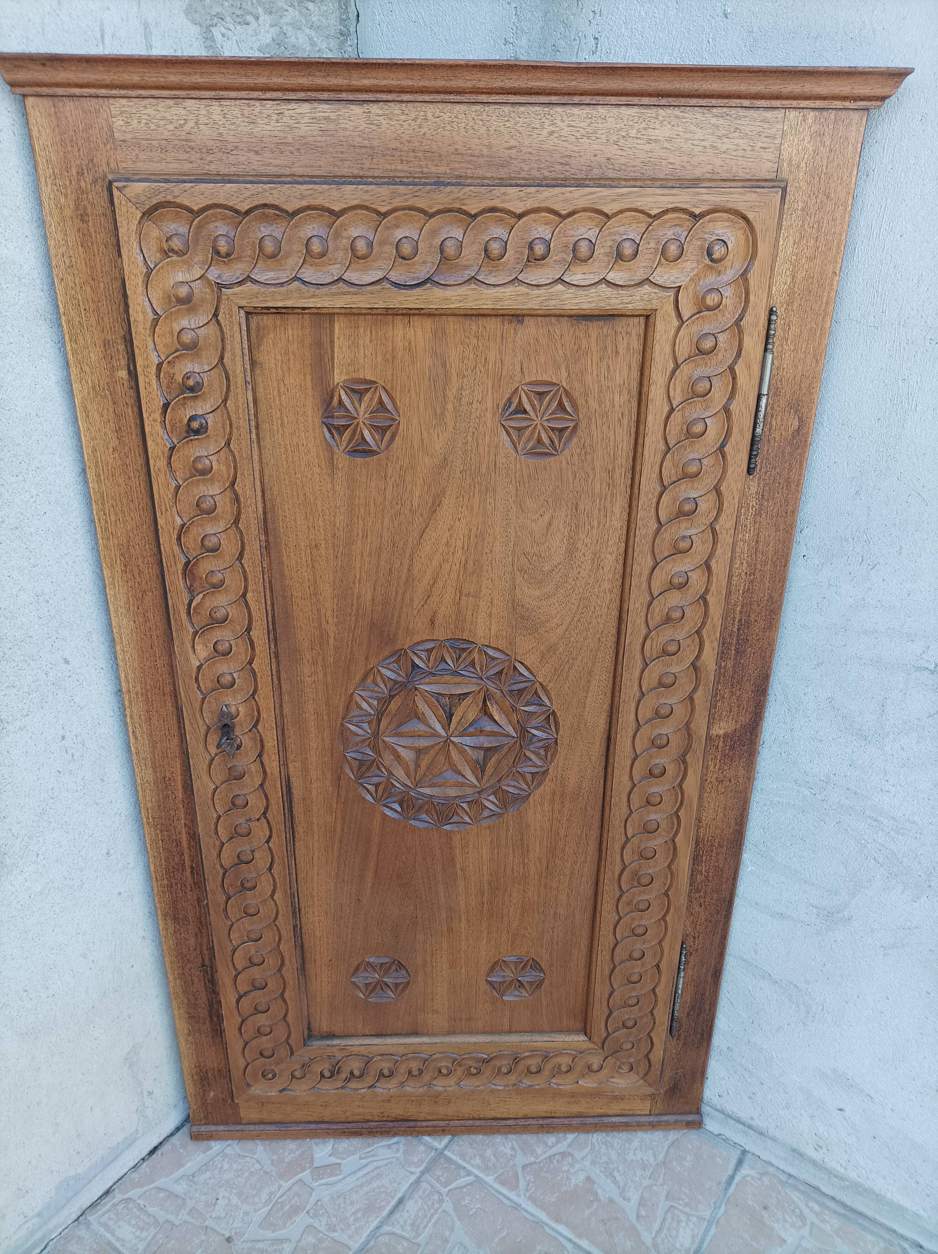 Corner cabinet in carved walnut, Savoyard style.