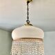 Pink half-shell suspension with pearl fringe