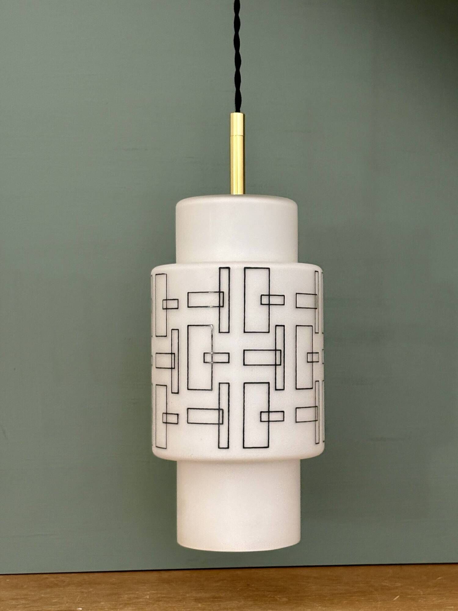 Vintage suspension globe in white opaline with black drawings.