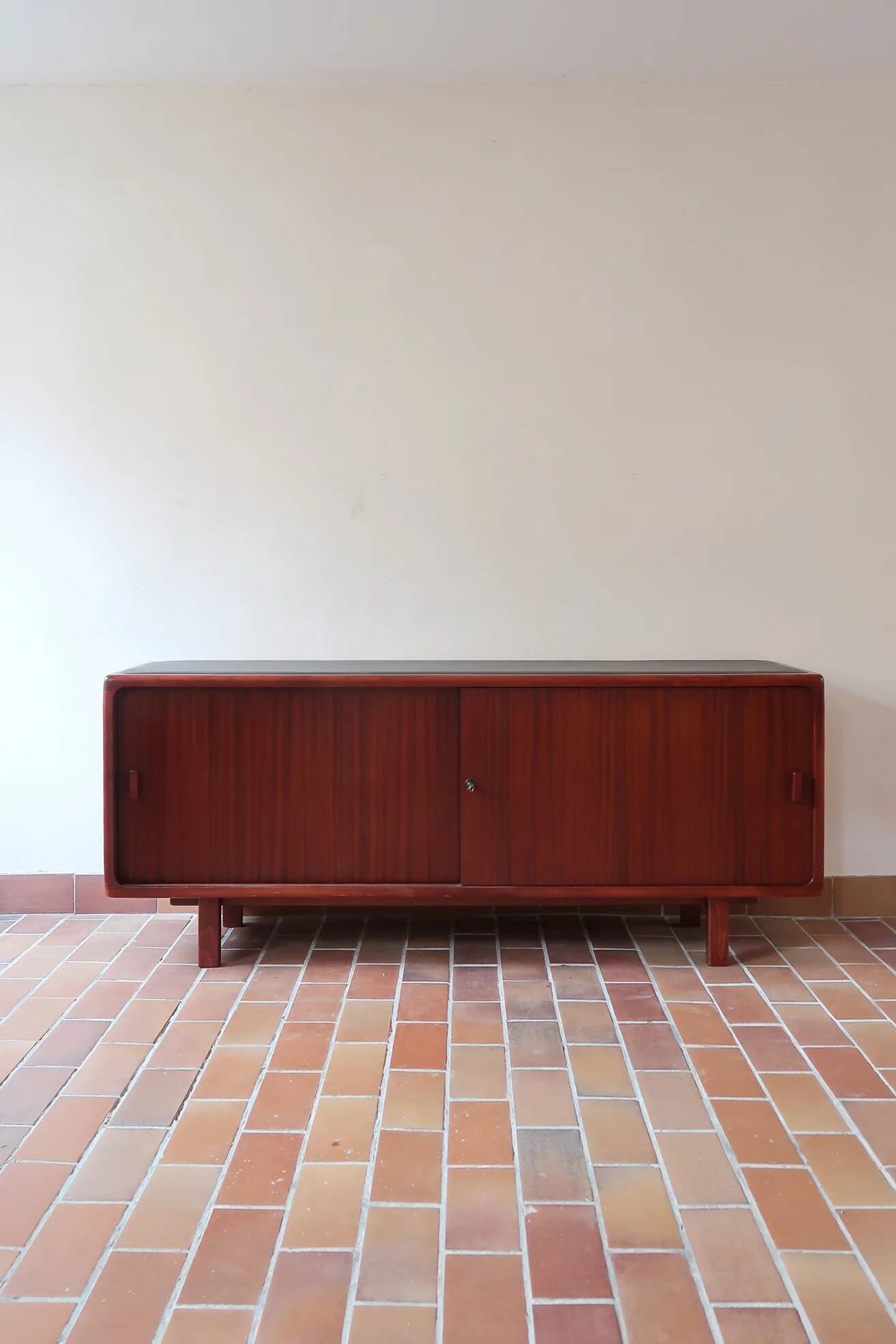Teak enfilade, sliding doors, black faux leather top, 1970s.