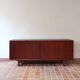 Teak enfilade, sliding doors, black faux leather top, 1970s.