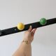 Wall-mounted coat rack, metal and colored wooden hook, 1960