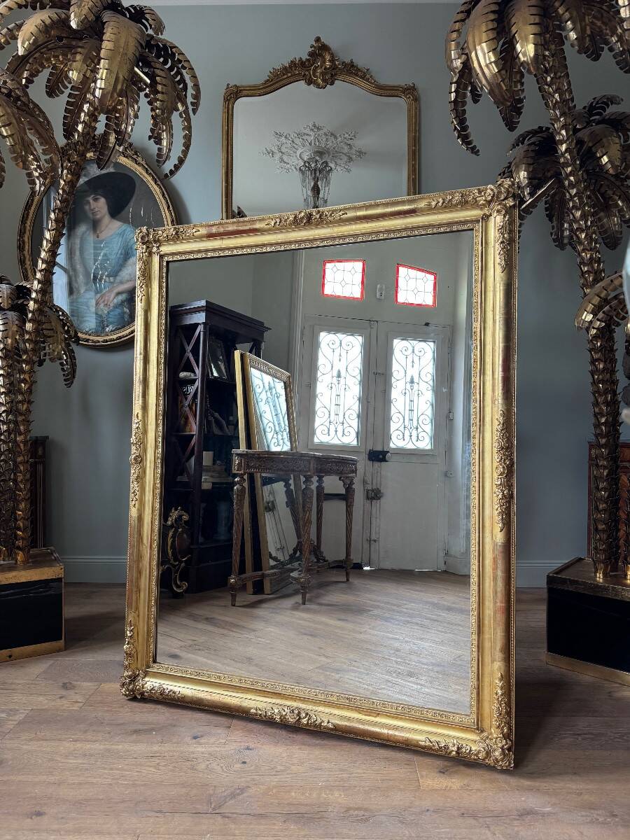 Restoration period mirror in gilded wood from the Napoleonic III era, 165 cm x 130 cm.