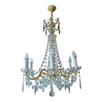 Antique chandelier with pendants in bronze and crystal.