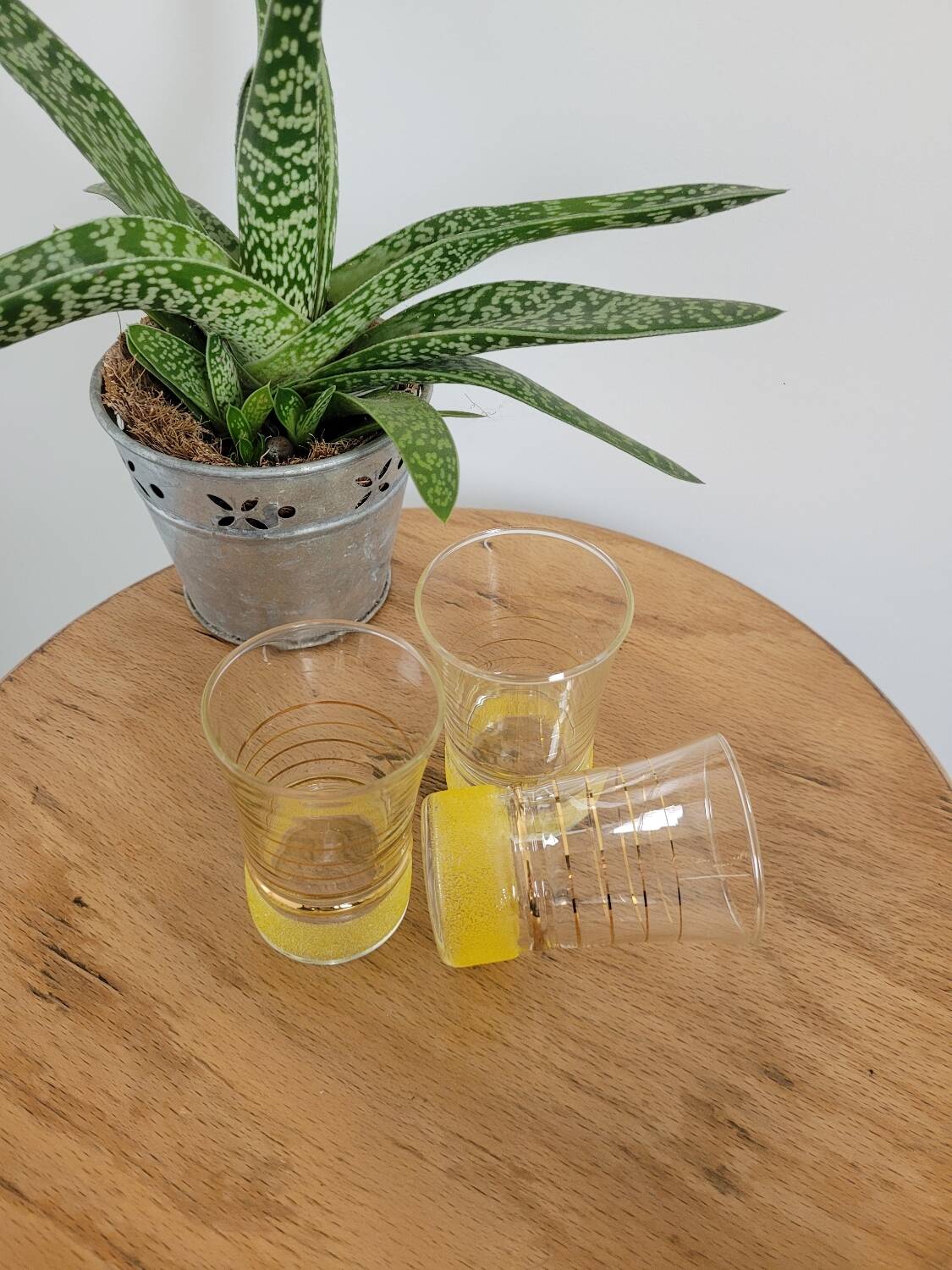 Trio of small yellow granite glasses with gold rims