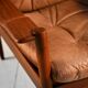 Scandinavian teak and leather lounge set with two armchairs and ottoman