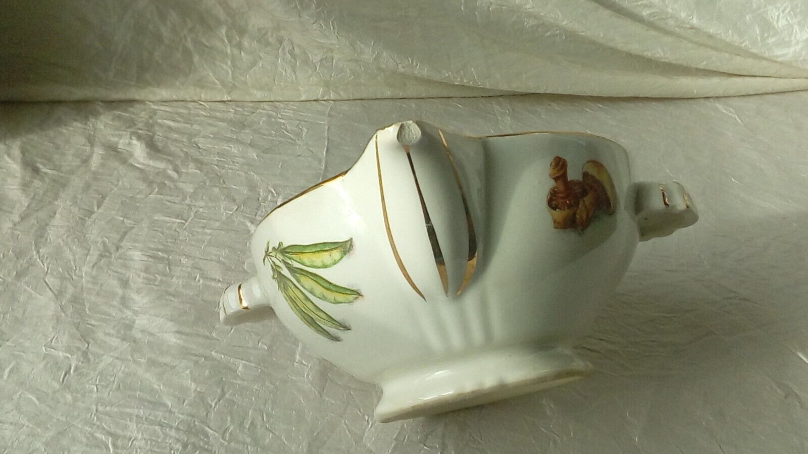 Sauceboat in earthenware decorated with four seasons vegetables.