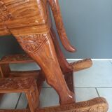 Decorative rocking elephant in carved exotic wood.