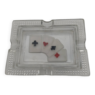 Glass ashtray with card game decoration.