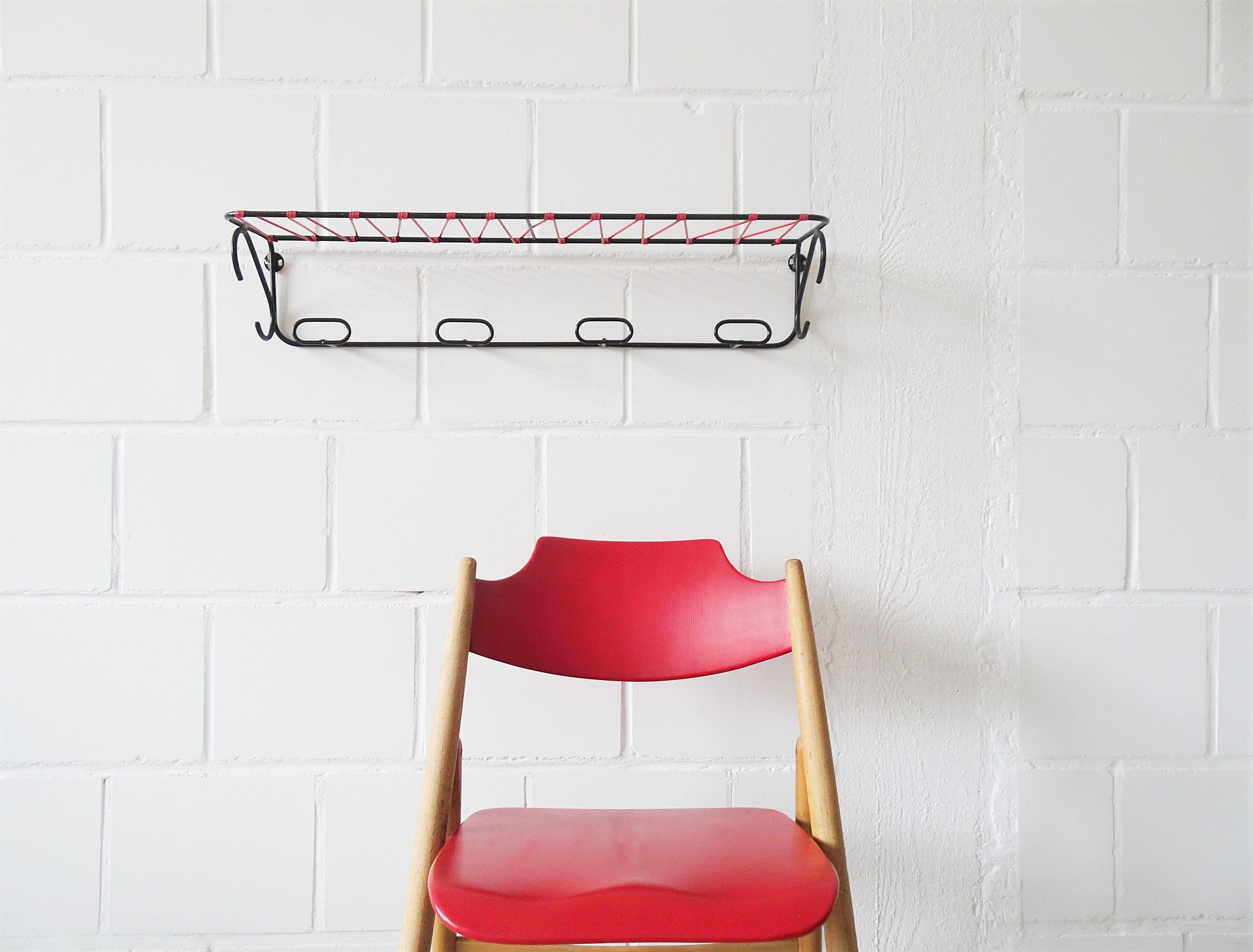 Minimalist wall coat rack in string design in black and red