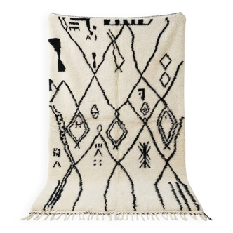 Moroccan Azilal rug with black patterns.