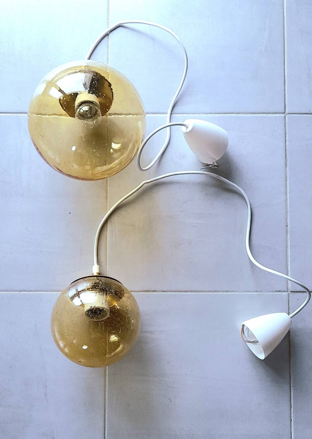 Set of 2 bubbled amber glass globe pendants