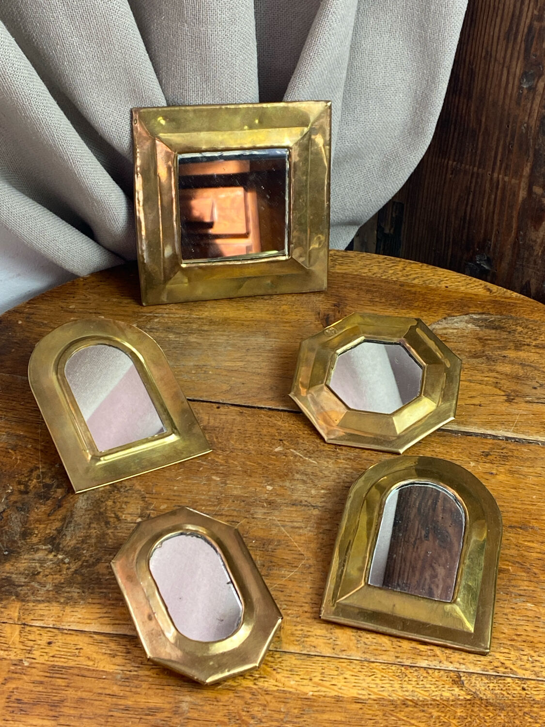 Set of five small wall mirrors in brass.