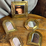 Set of five small wall mirrors in brass.