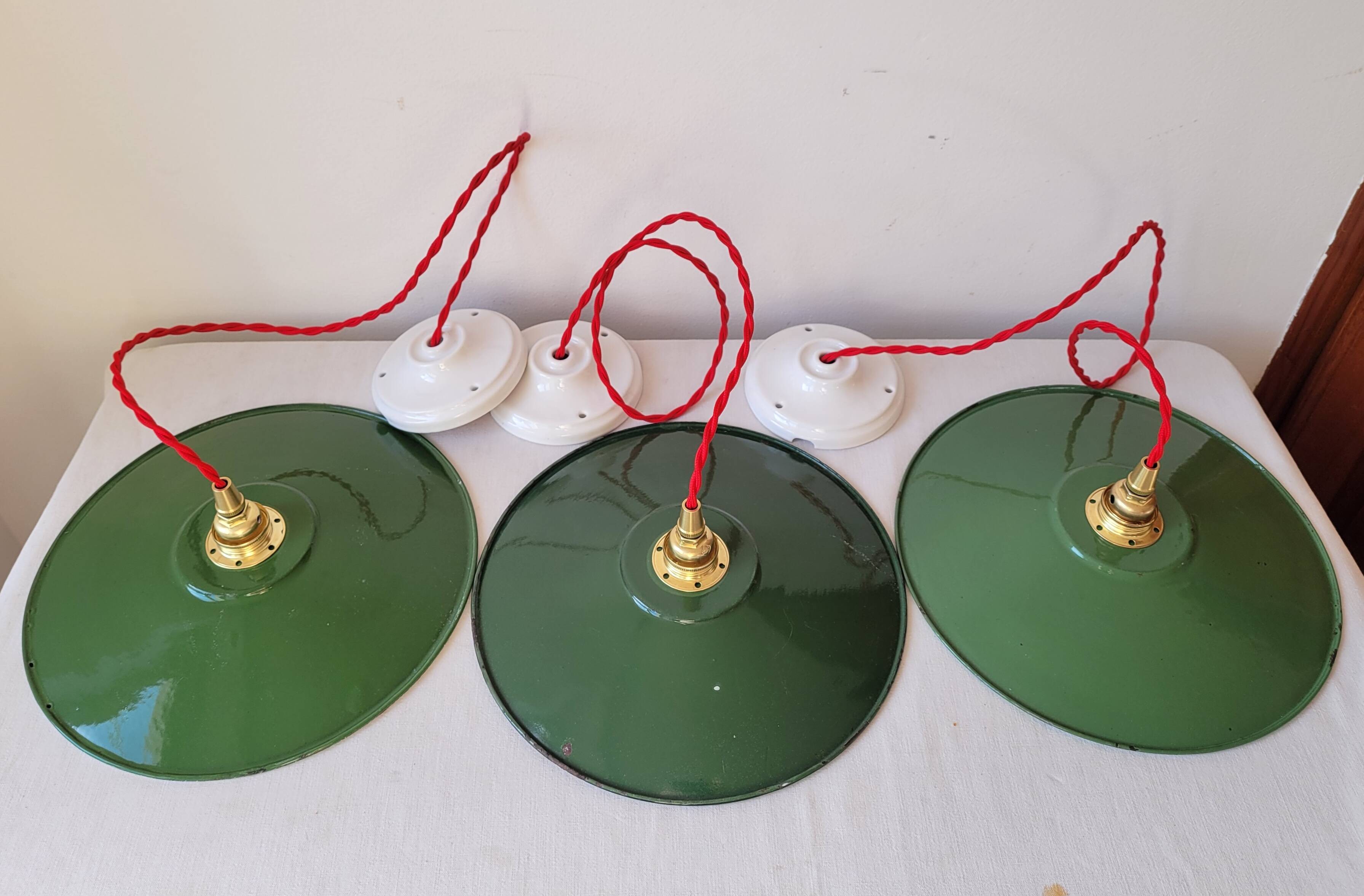 Trio of enameled sheet metal pendant lights