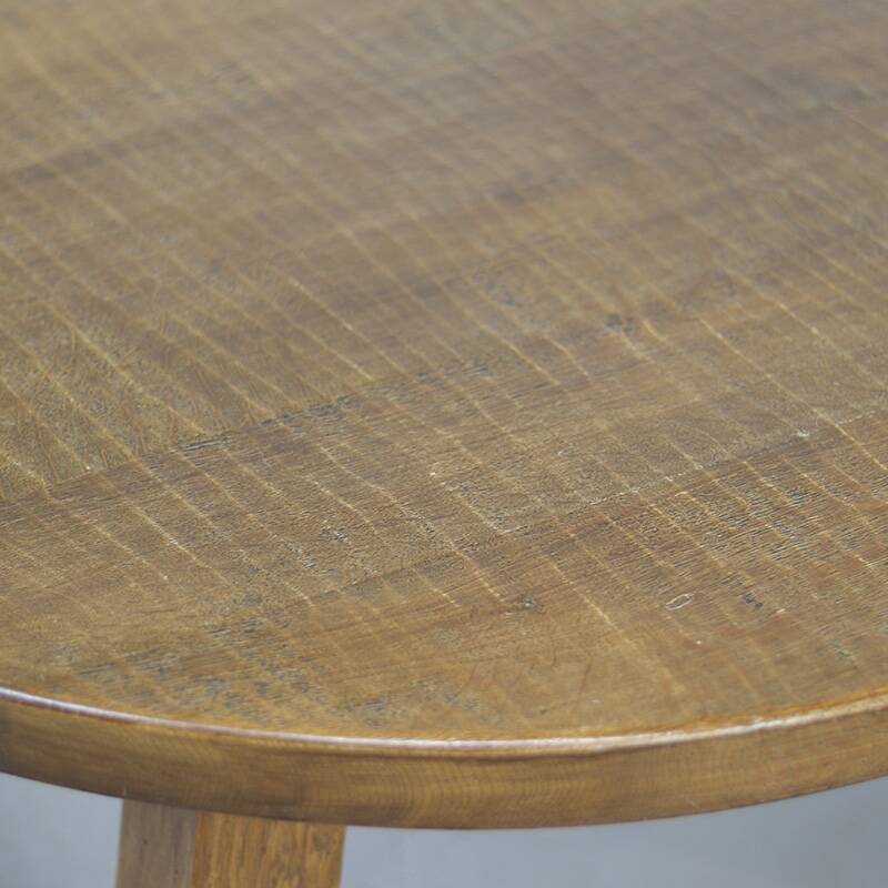 Large rustic vintage coffee table in a round brutalist style.