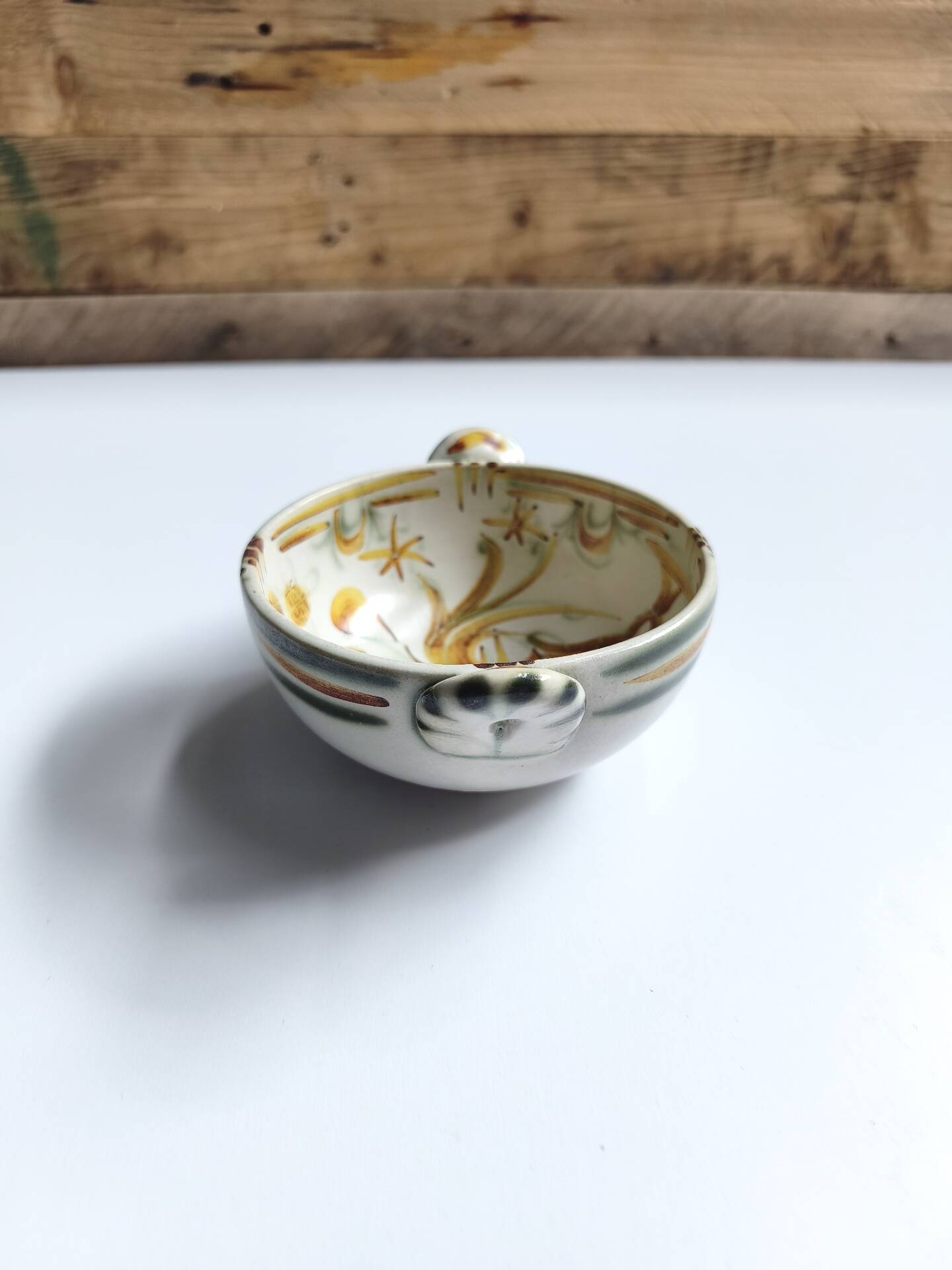 Vintage bowl signed Keraluc Quimper in yellow and green.
