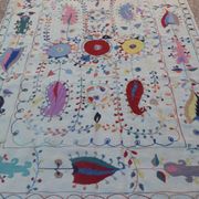 White suzani kilim rug with hand embroidered multi-colored patterns