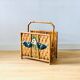 Vintage rattan magazine holder with floral decoration