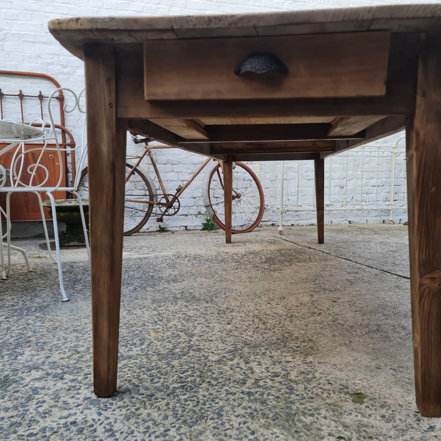 Large antique farmhouse table with a drawer