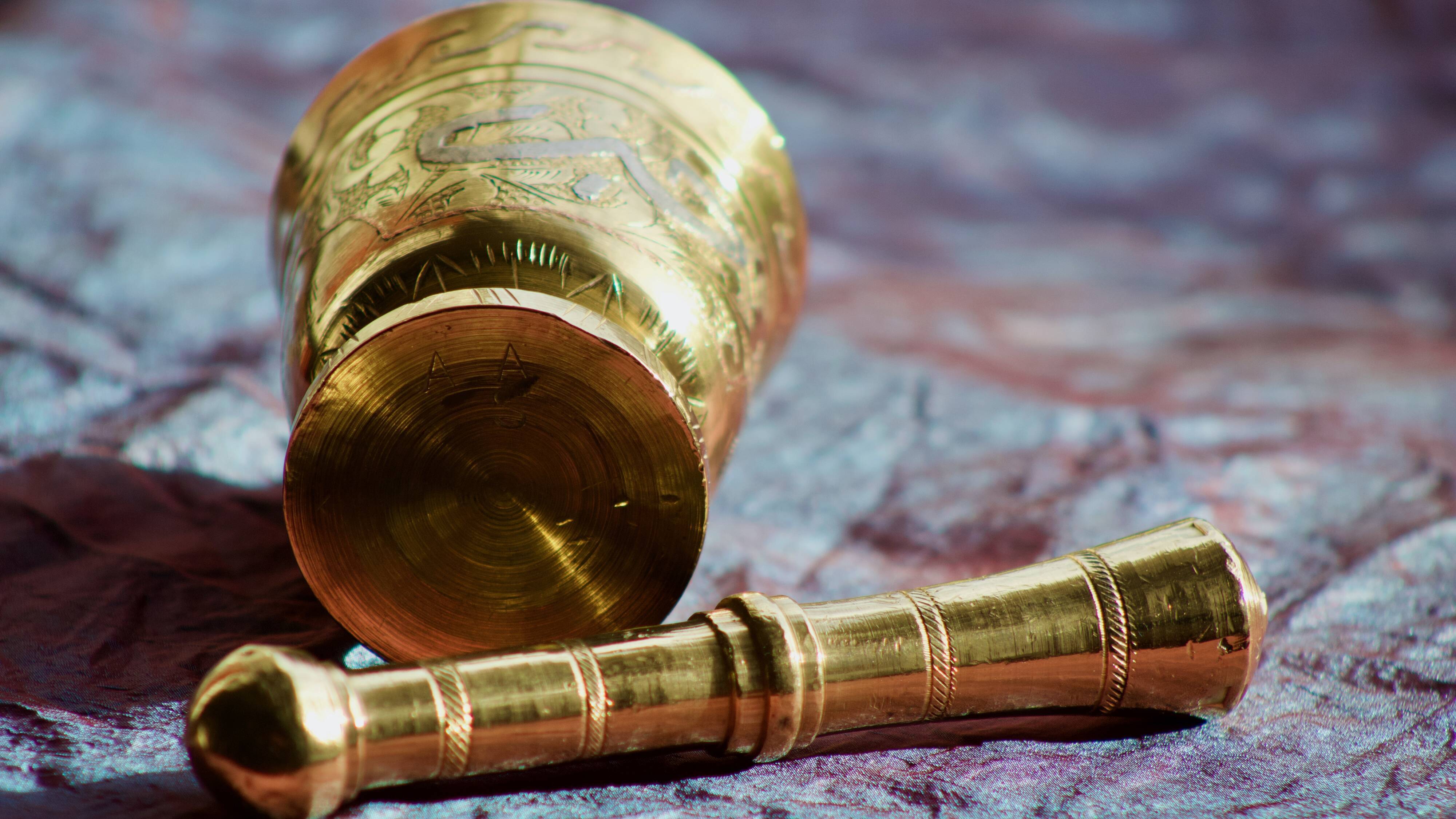 Mortar and its brass pestle with oriental gold and silver motifs