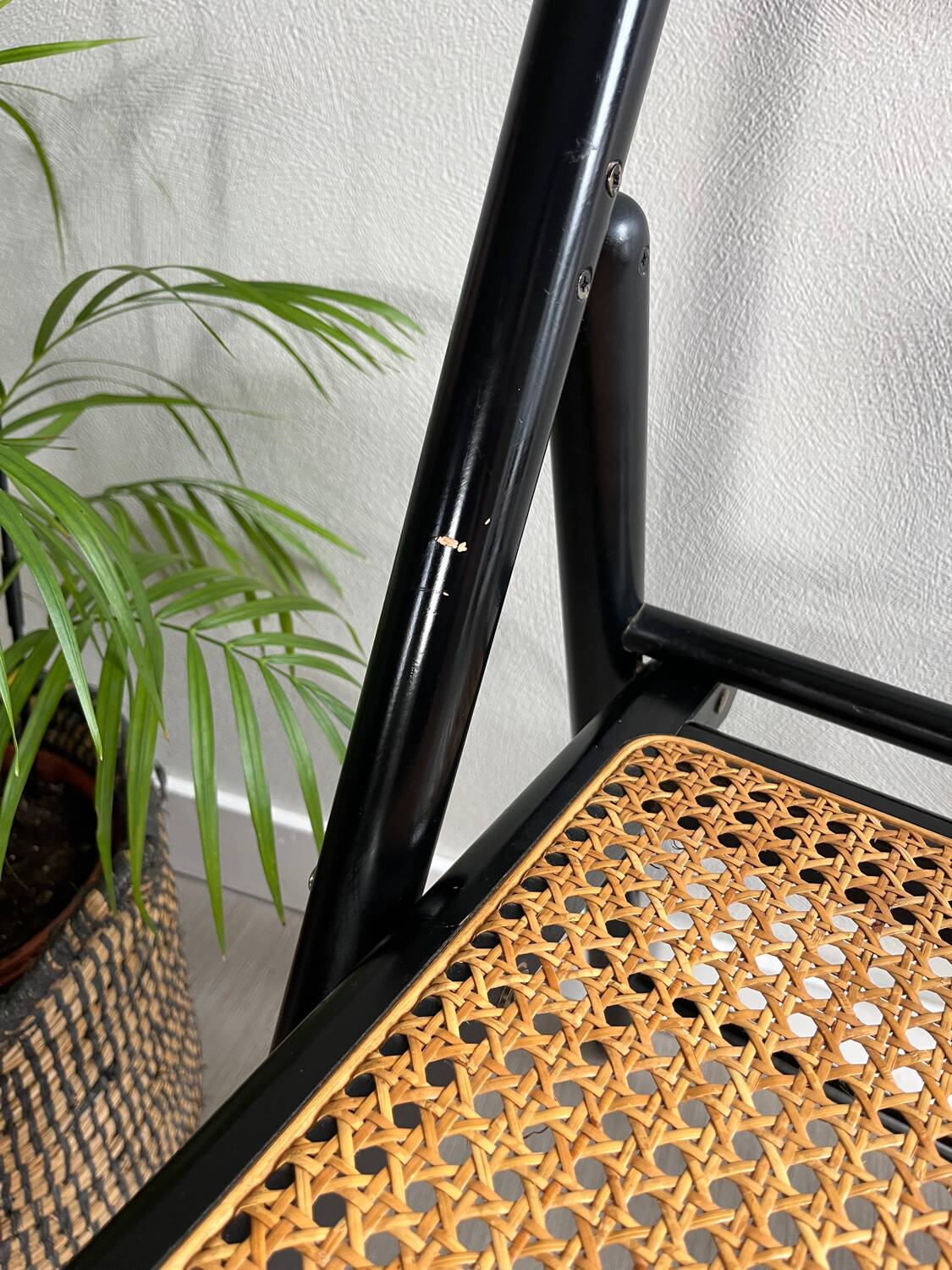 Vintage folding chairs in black wood and cane.