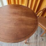 Round cherry table with extension, 3 chairs and 1 armchair.