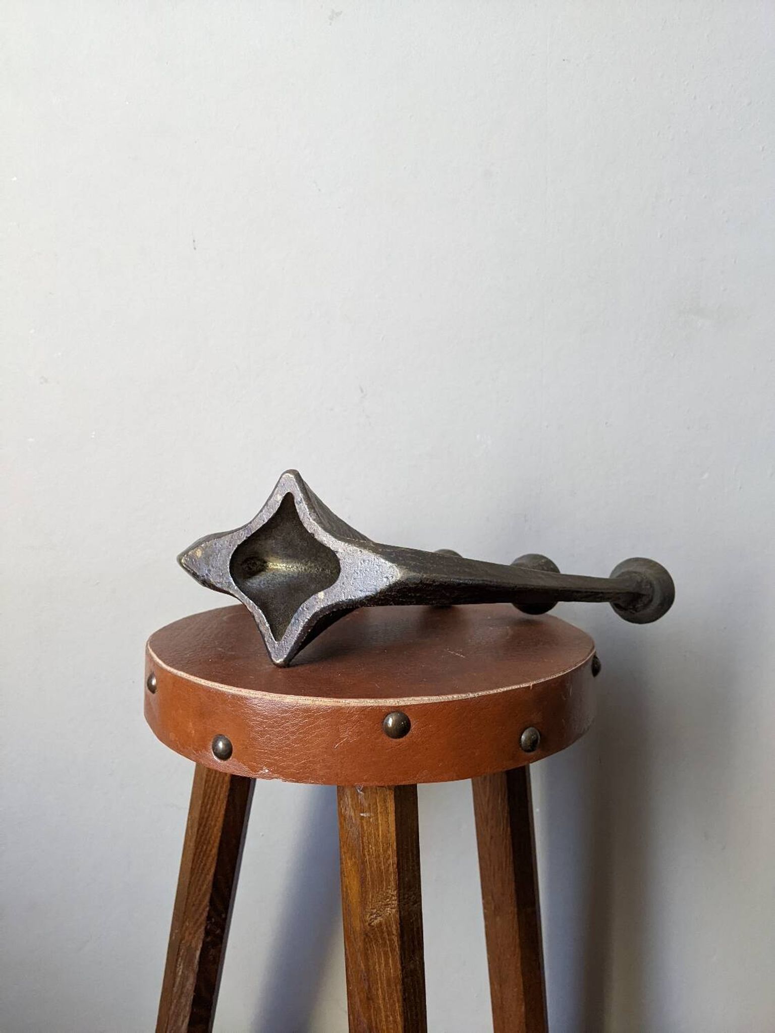 Vintage bronze candlestick chandelier in contemporary Scandinavian design.