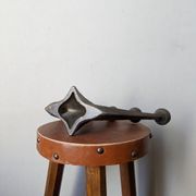 Vintage bronze candlestick chandelier in contemporary Scandinavian design.